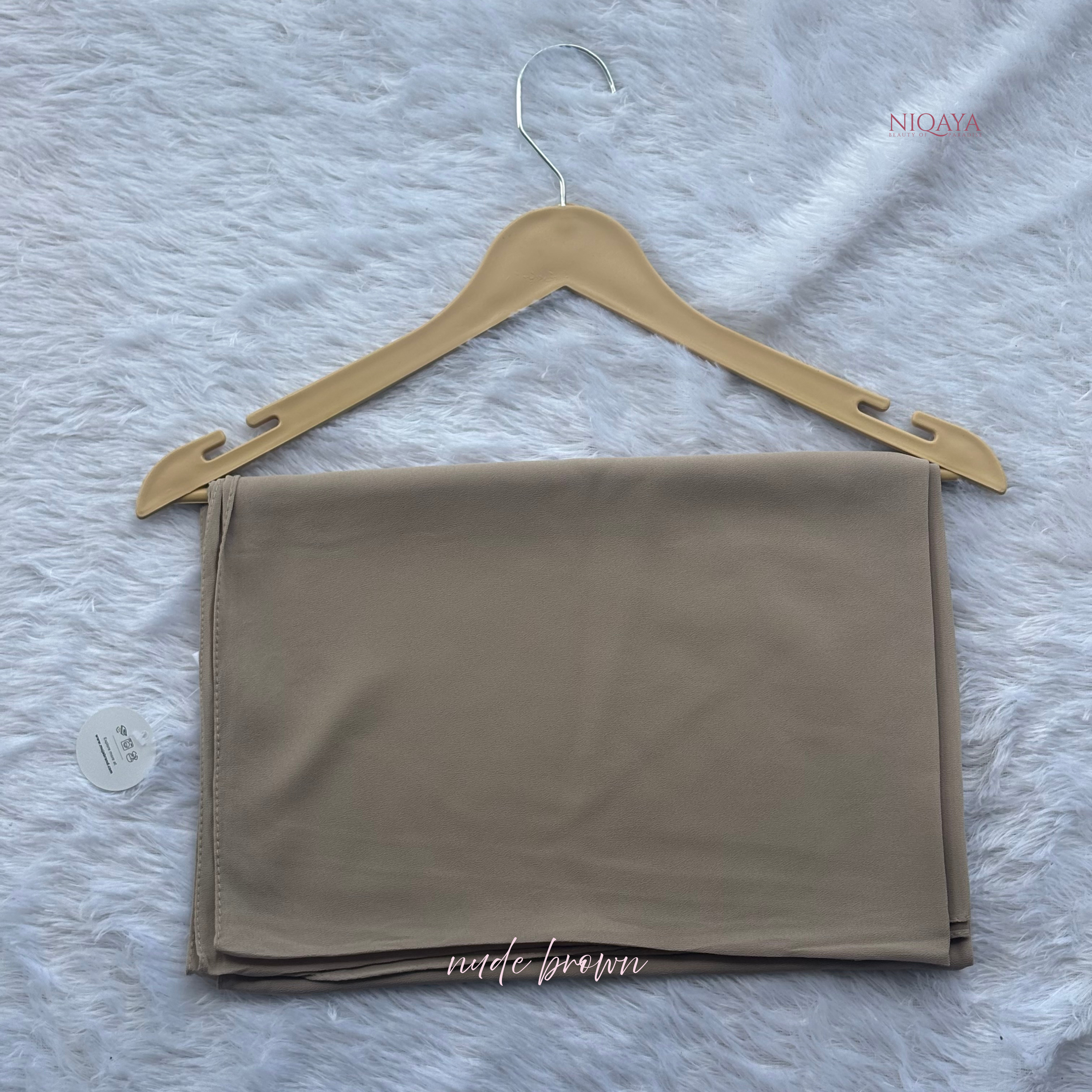 Beige fabric on a hanger with a gray background