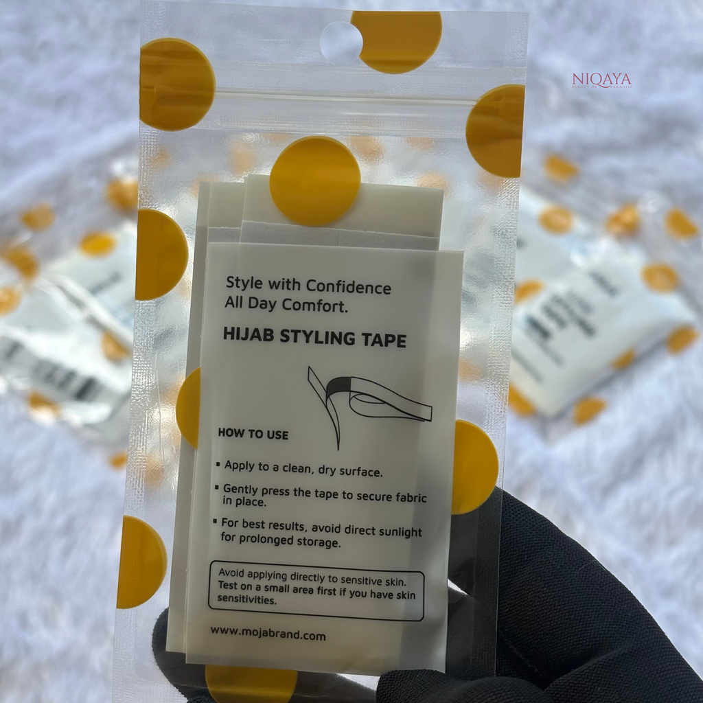 Packaging of hijab styling tape with instructions and brand name on a white background.