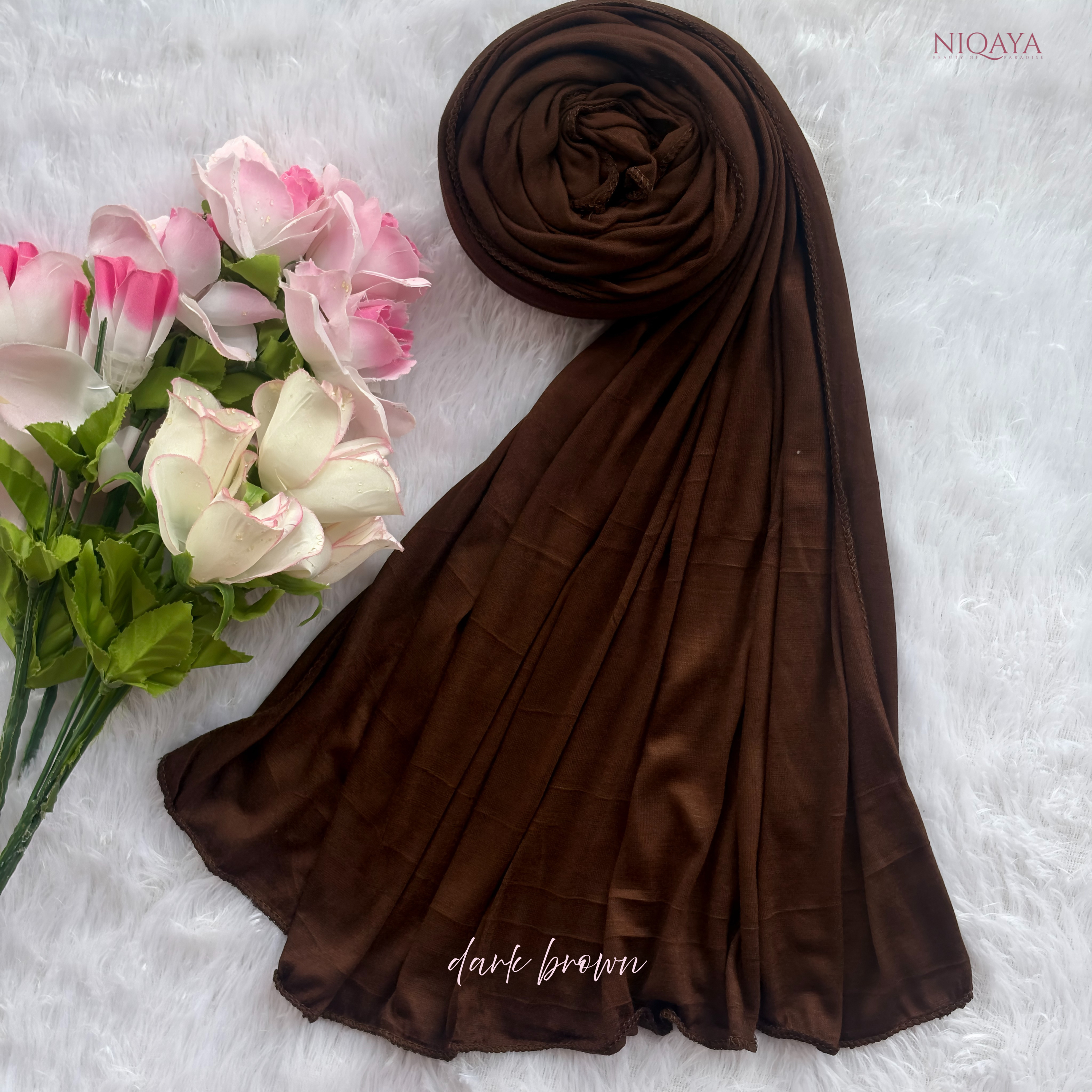 Dark brown hijab with pink and white roses on a light gray background