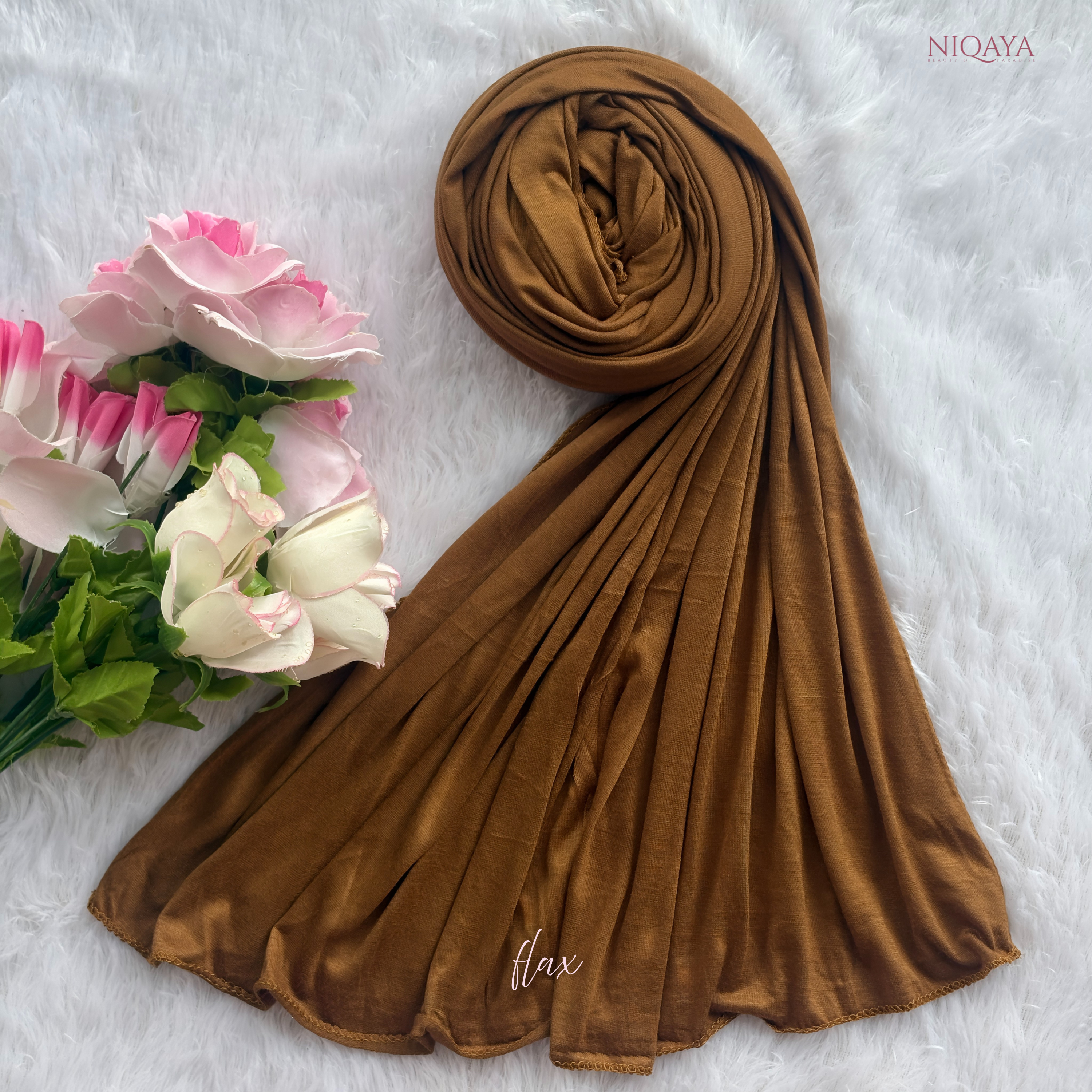 Brown hijab with flowers on a white background, featuring the brand 'Niqaya'.