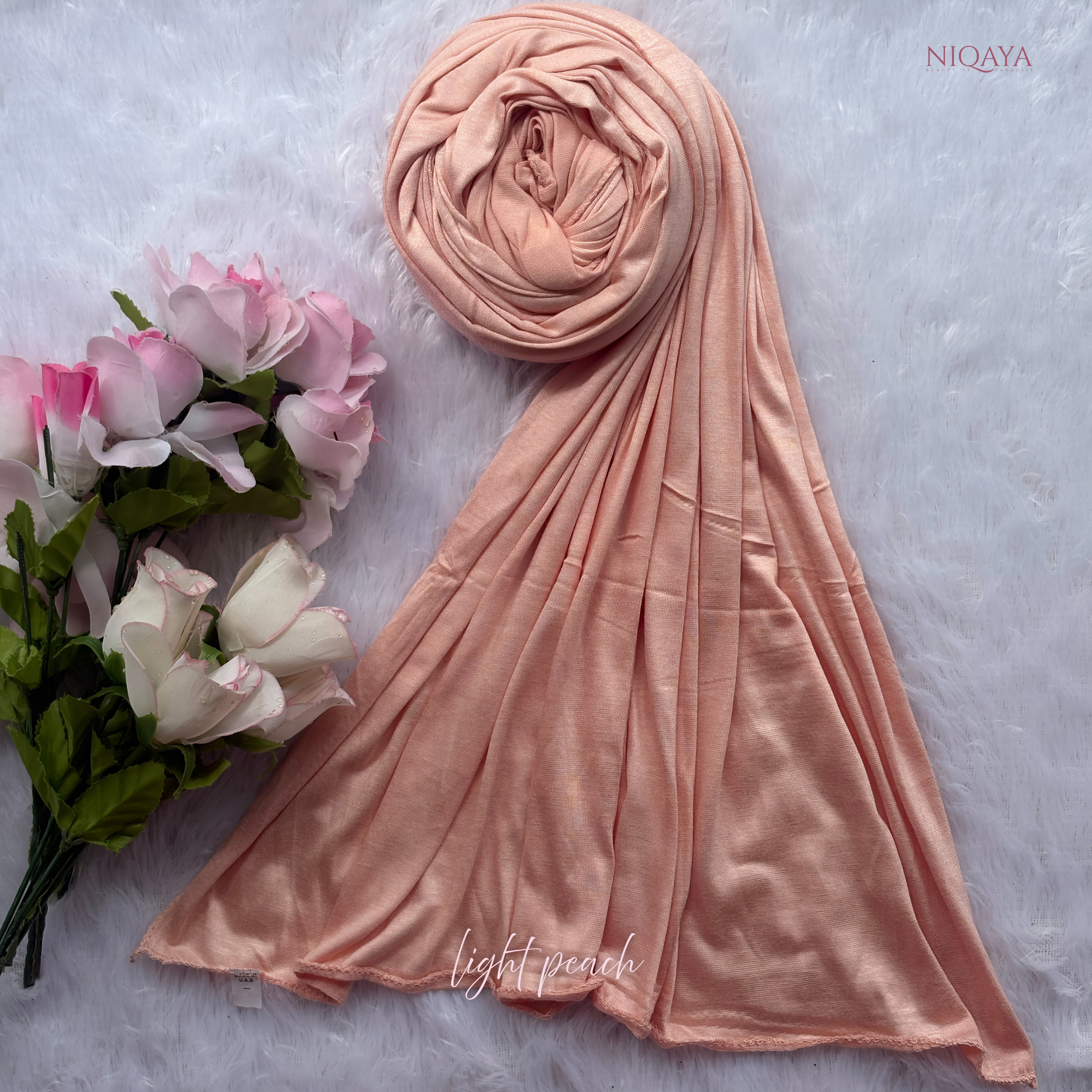 Light peach hijab with a bouquet of flowers on a textured light gray background