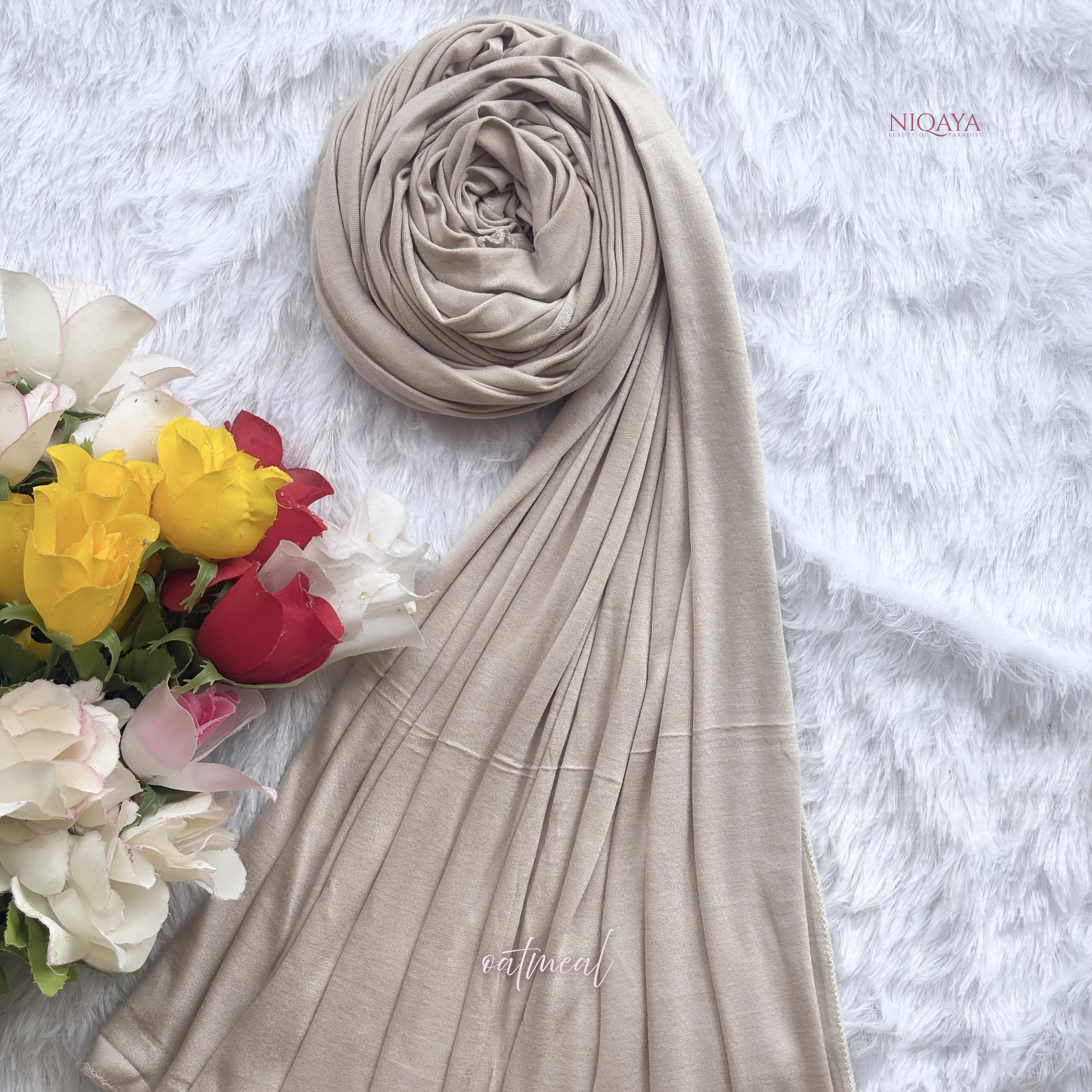 Beige hijab with flowers on a textured white background