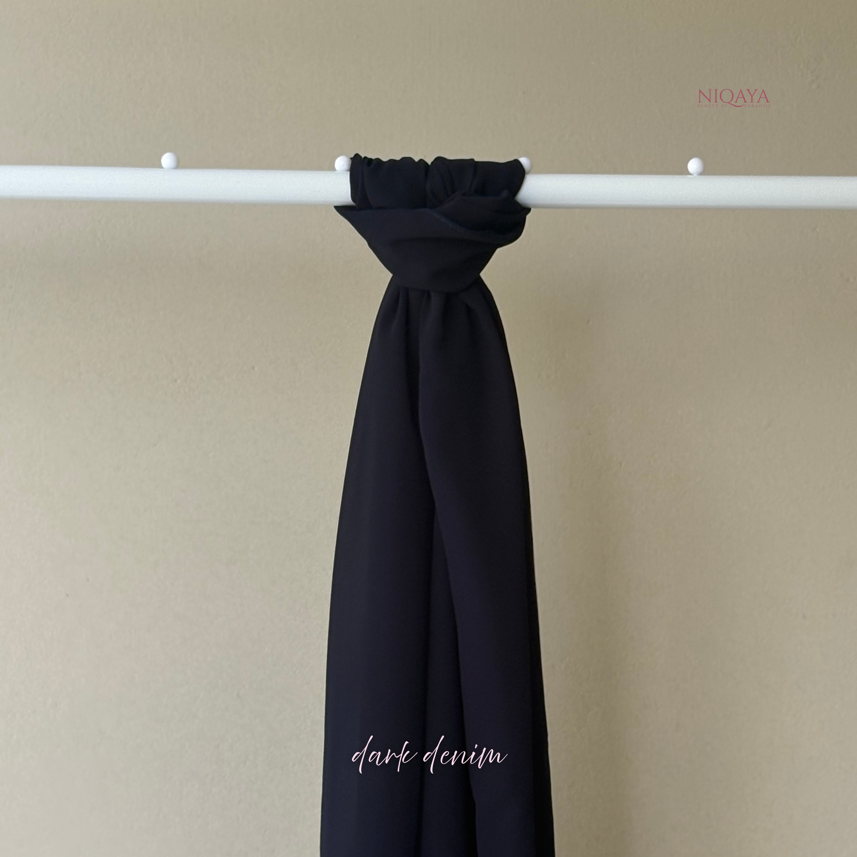 Black fabric swatch on a beige background with 'Niqaya' branding.